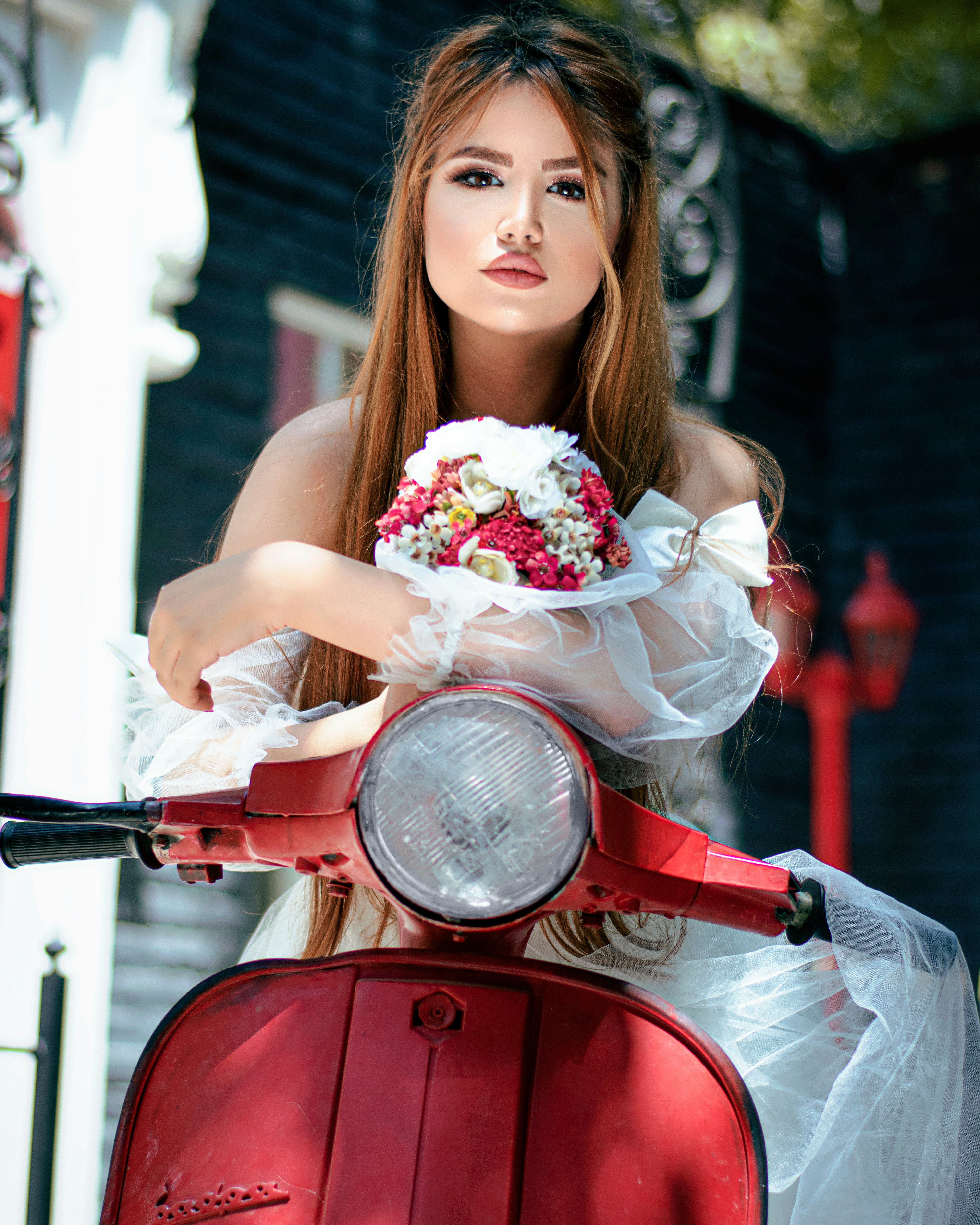 woman in white dress holding bouquet of flowers